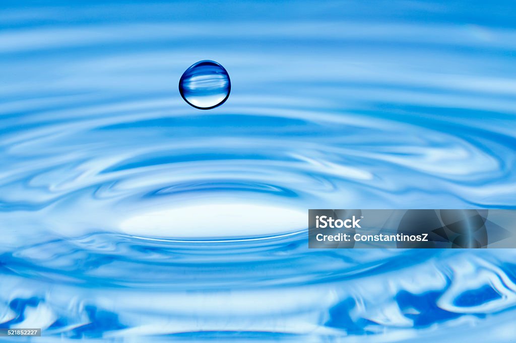 water drop water drop over rippled water surface Abstract Stock Photo