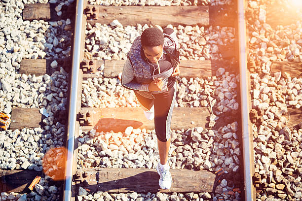 Portrait of Happy Girl Wearing Sunglass Is Standing on the Railway. Blurry Background, Soft Golden Hour Light