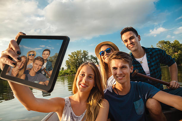 istock Cheerful Friends Taking Selfie On A Boat 521871883