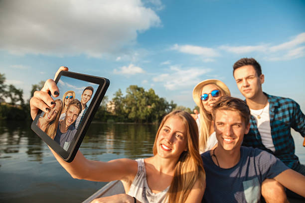 istock Cheerful Friends Taking Selfie On A Boat 521871893