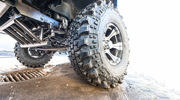 istock Car tire with offroad pattern close-up on road. 521873785