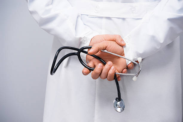 istock Male doctor holding stethoscope 521873939