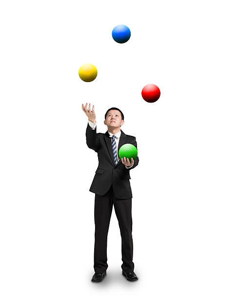 abito nero uomo d'affari fare il giocoliere palline colorate - juggling efficiency skill businessman foto e immagini stock