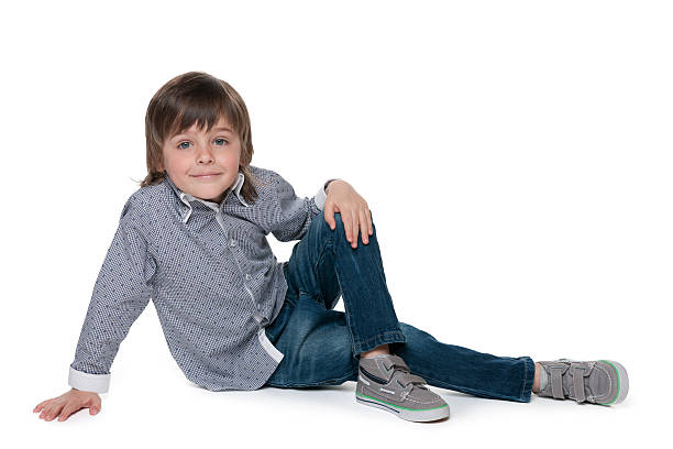 istock Cute little boy sits on the floor 521876089