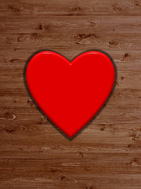 istock Read heart and wooden background 521876541