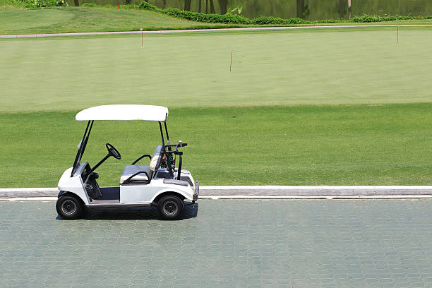 istock golf car in green golf course 521893275