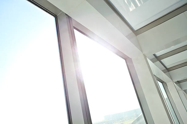 istock Sunny on modern glass office windows building interior corridor 521894531