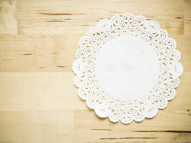 Lace paper on wooden table stock photo