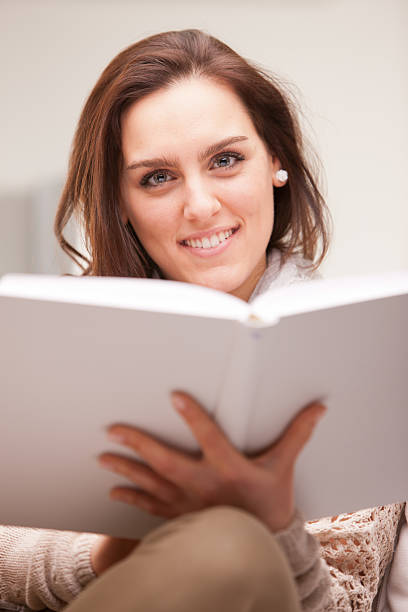 istock beautiful fascinating woman reading a book 521907241