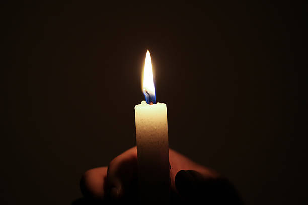 istock Holding a candle in darkness 521910435