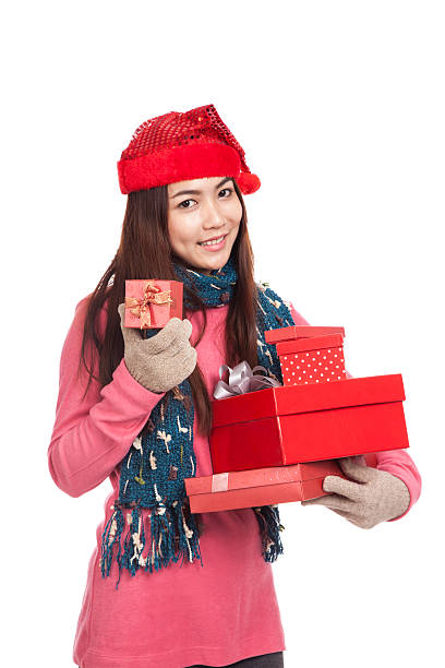 istock Asian girl with red christmas hat with many gift boxes 521910565