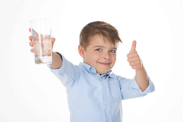 ok it is fresh young boy says ok holding a glass of water little boys blue eyes blond hair one person stock pictures, royalty-free photos & images