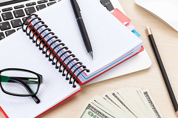 istock Office table with pc, supplies and money 521911999