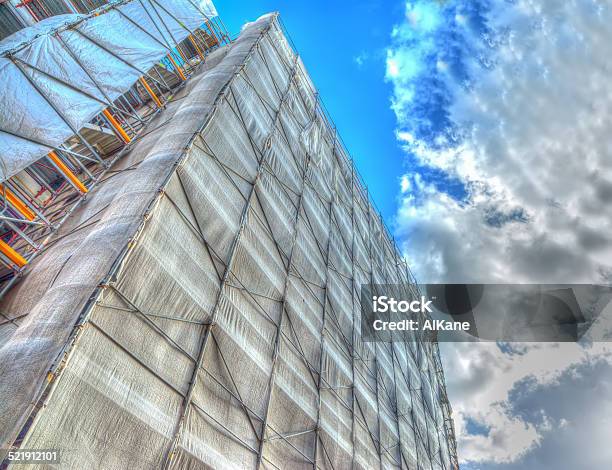 Building Facade Covered For Restoration Work Under A Cloudy Sky Stock Photo - Download Image Now