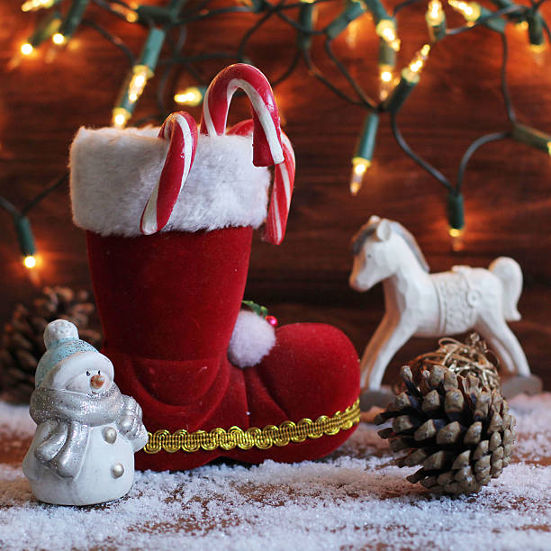 istock boots, rocking horse, and teddy bear on christmas background 521929493