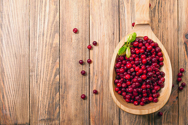 istock cranberries in a wooden spoon 521930167