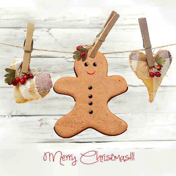 hanging gingerbread man over wooden background