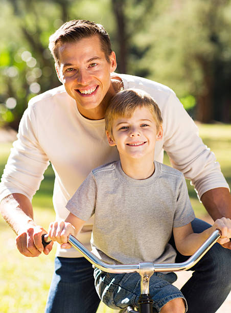 istock father and son riding a bicycle 521931779