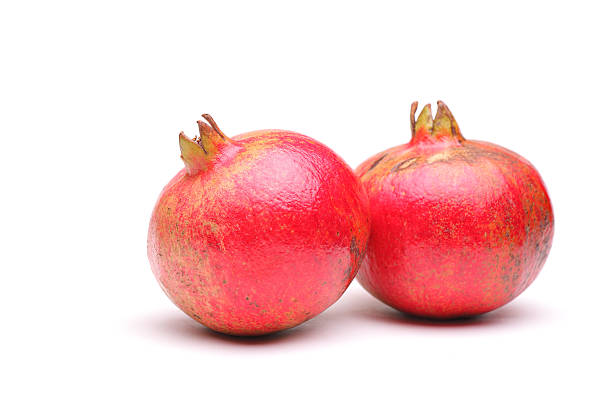 istock Studio shot of two pomegranates 521932673