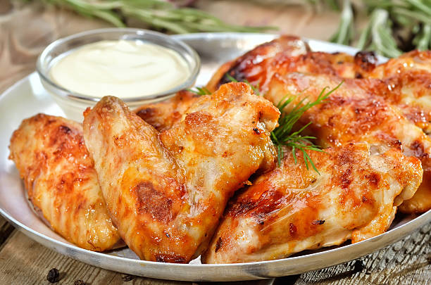 istock Fried chicken wings with sauce, close up view 521934391