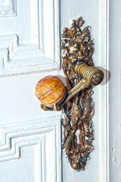 old metal door-handle on a wooden door