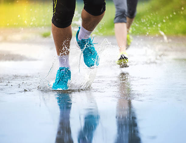 istock Couple running in rainy weather 521952265
