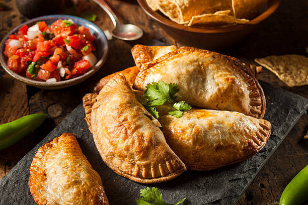 Homemade Stuffed Chicken Empanadas Homemade Stuffed Chicken Empanadas on a Background argentinian culture stock pictures, royalty-free photos & images