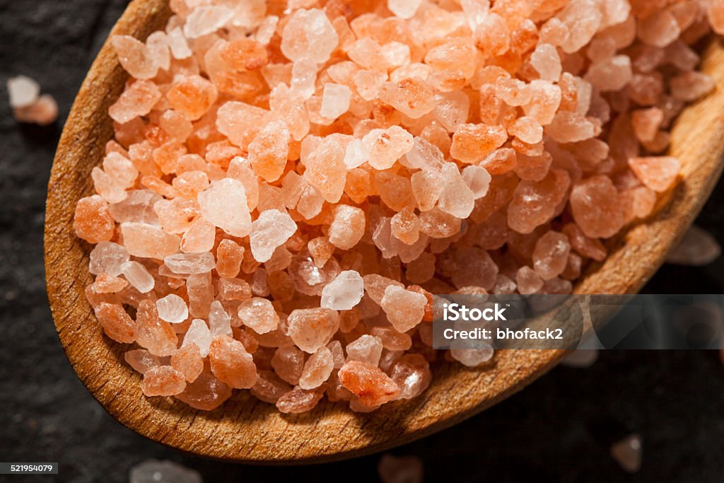 Raw Pink Himalayan Sea Salt Raw Pink Himalayan Sea Salt in a Spoon Alternative Therapy Stock Photo