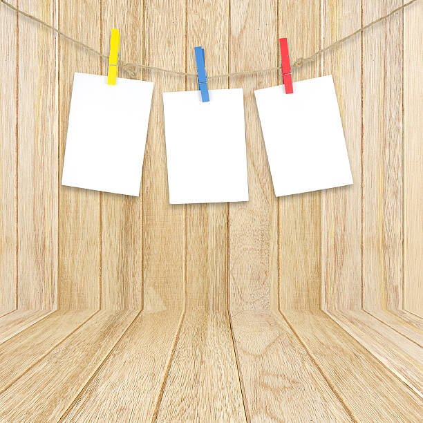istock empty white photo frames hanging with clothespins on wooden back 521955369