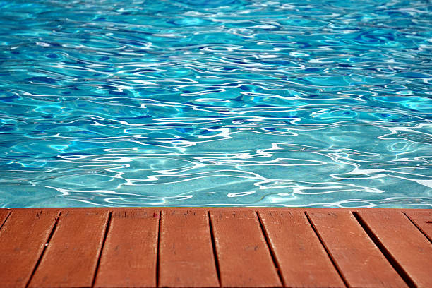 istock blue swimming pool with wood flooring stripes summer vacation 521955657