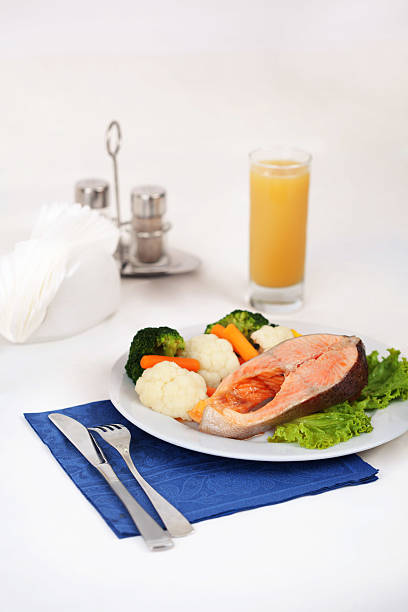 salmon steak with steamed vegetables stock photo