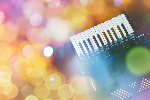 Accordion with color bokeh light in background
