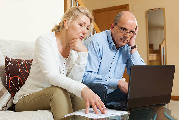 istock Serious mature couple  with laptop 521957325
