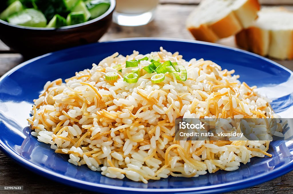 Rice with vermicelli Rice with vermicelli on a dark wood background. Traditional Arabic dish. tinting. selective focus on green onions Cauliflower Stock Photo