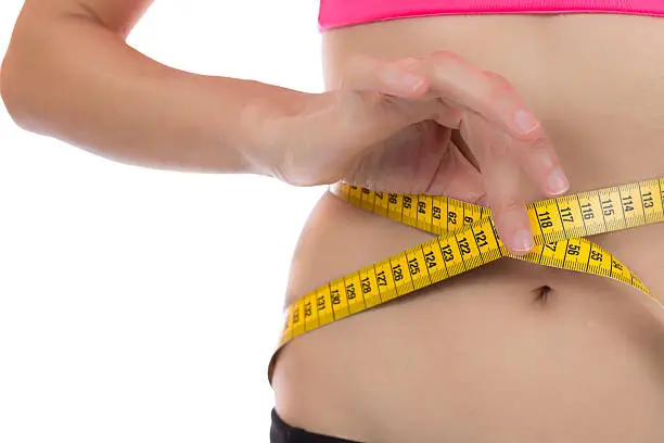 Photo of Weight loss woman with a measurement tape