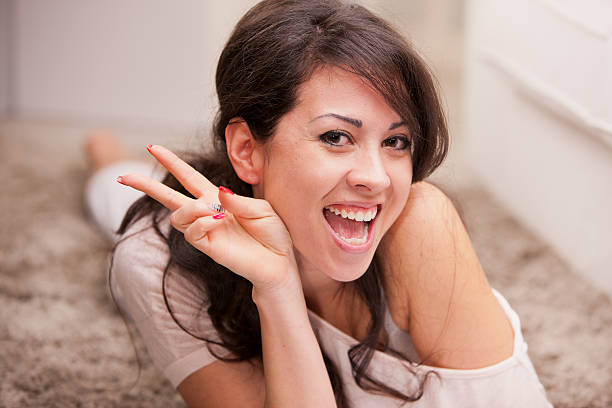 istock girl simulating victory sign with her fingers 521959033