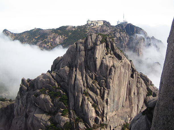 THe yellow mountrains in china hidden mist giving it a very mysterious look.