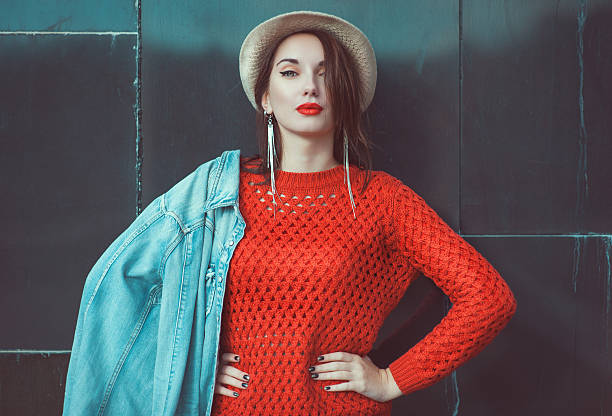 istock Young beautiful girl in red jersey with hat 521970965