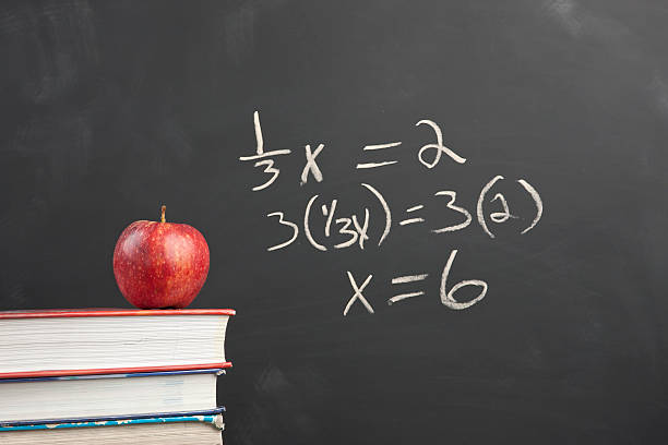 Red apple and algebra equation. An apple on stack of books by an algebra equation on the blackboard. algebra photos stock pictures, royalty-free photos & images