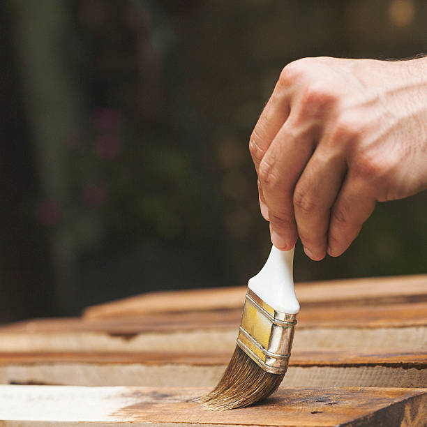 istock Man painting the fence 521971309