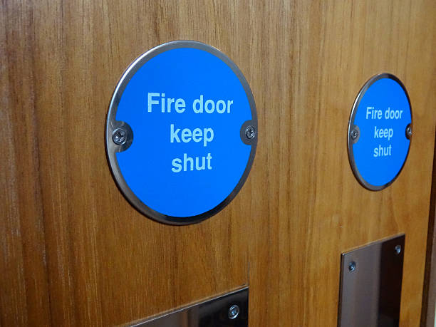 Image of circular blue Fire Door Keep Shut safety sign stock photo