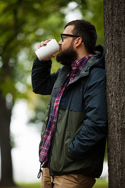 istock Man With Beard And Glasses Holding Coffee 521972243