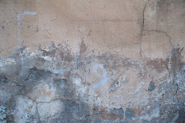 istock Texture of old wall covered with yellow stucco 521972547