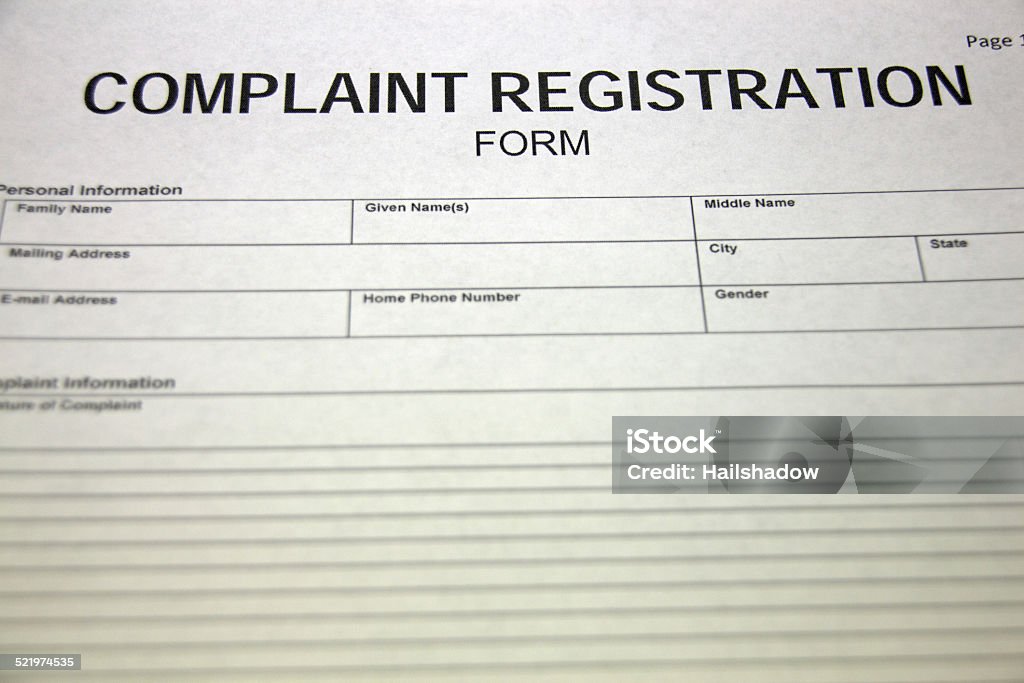 Complaint registration form Someone filling out a complaint registration form. Agreement Stock Photo