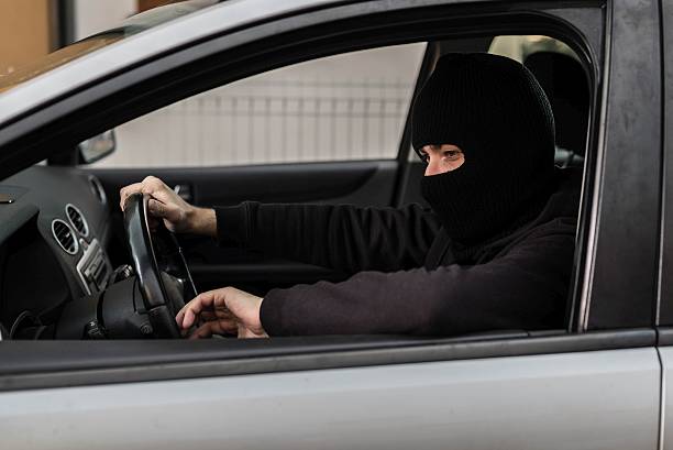istock Car thief driving a stolen car. 521974996
