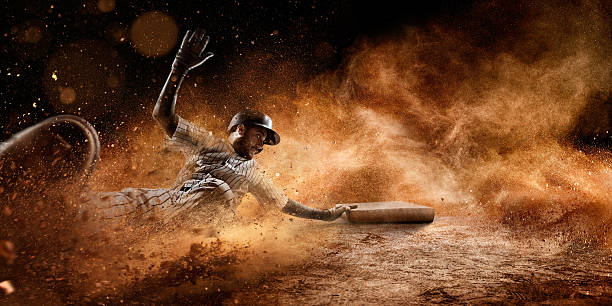 Sliding on third base Close up image of a baseball player sliding during a baseball game. He is wearing unbranded generic baseball uniform.  base sports equipment photos stock pictures, royalty-free photos & images