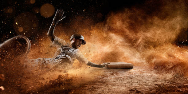 Sliding on third base Close up image of a baseball player sliding during a baseball game. He is wearing unbranded generic baseball uniform. base sports equipment photos stock pictures, royalty-free photos & images