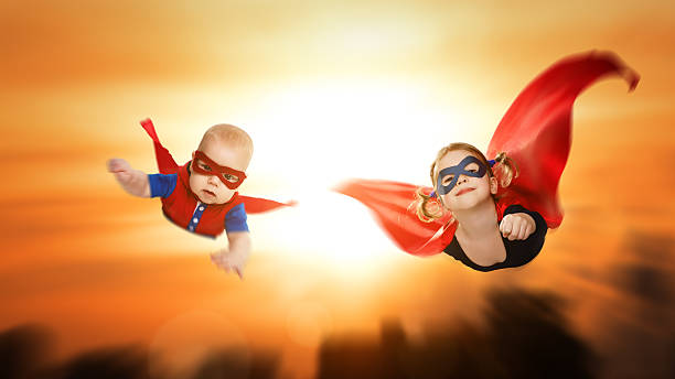 istock children superheroes flying across sunset sky 521976502