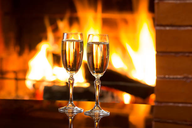 istock Sparkling wine in front of warm fireplace. Romantic, cozy atmosphere 521976718