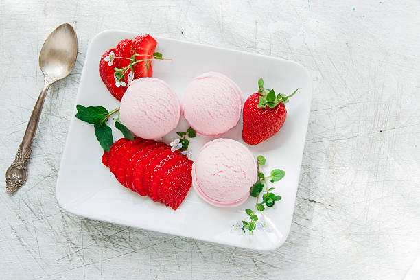 istock strawberry ice cream ball with fresh strawberries 521977156